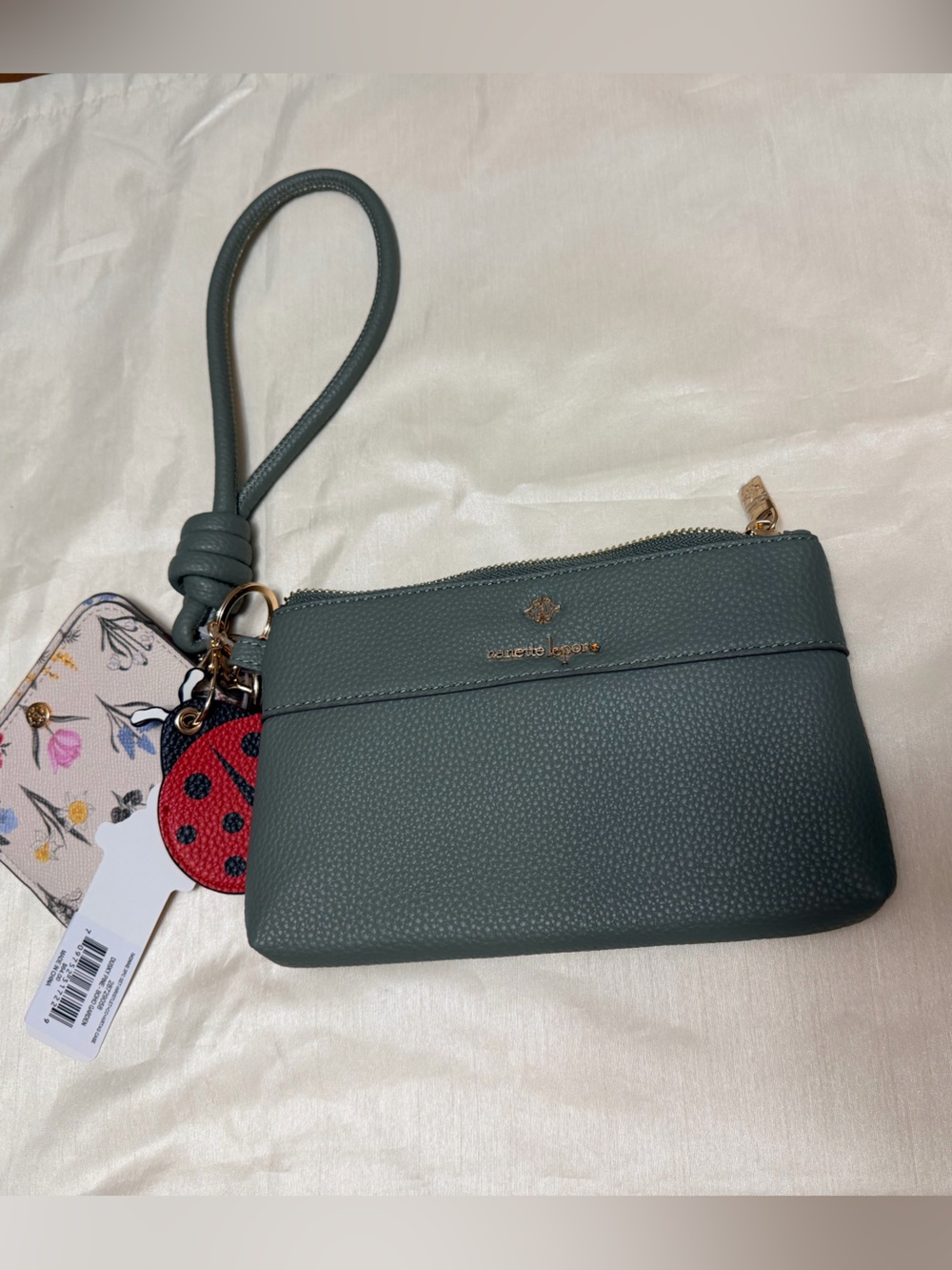 Nanette Lepore Sage Green Pebbled Wristlet with Floral Charm